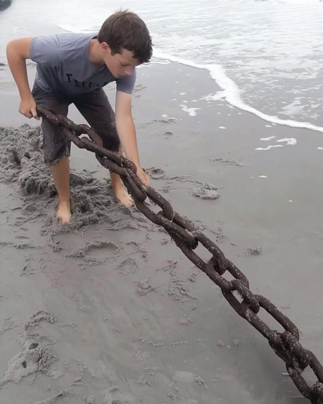 A POOR BOY’S LIFE CHANGES AFTER HE PULLS AN OLD, RUSTY CHAIN STICKING OUT OF THE SAND ON A REMOTE BEACH Adam is 13 years old and lives with his grandfather in an old trailer near the ocean. His parents passed away when he was just 3, and since then, his grandpa has been his only family. They don’t have much, but his grandpa has raised him well—Adam is strong, smart, and way more mature than most kids his age. One afternoon, he rode his bike down to the beach, just like any other day. He wandered along the shore, letting the waves tickle his feet—until something caught his eye. A thick, rusted chain lay partially buried in the sand. Curious, Adam grabbed it and pulled—but it barely budged. Whatever it was connected to was massive. From that moment on, Adam became obsessed with digging. He had no idea what he was about to uncover—or how it was about to change his life forever ⬇️