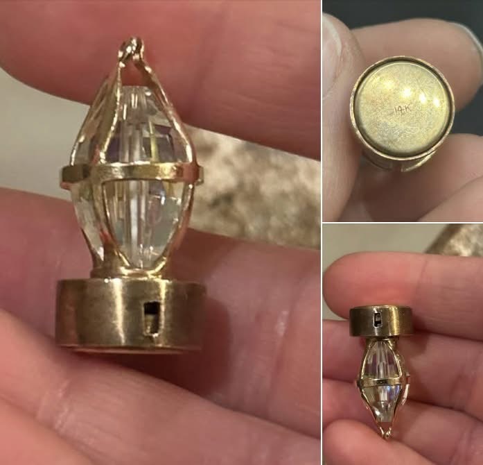\”I came across a small, gold-colored item about an inch long, stamped 14K on the bottom. It’s lightweight, and the bottom piece clicks in and moves. The bottom is magnetic, but the top isn’t. It has a crystal in the center. I found it while thrifting among a bag of random items. Any ideas what it is?\” More details in the comments below…⬇