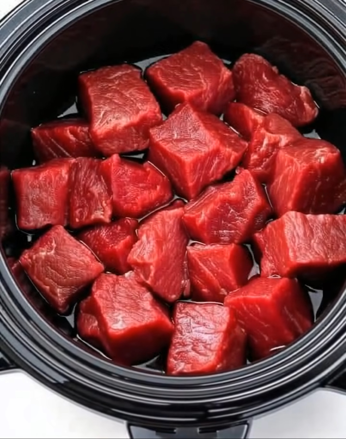 Put raw cubed beef in a slow cooker with these 3 ingredients. You won’t believe how good it is.. Full recipe