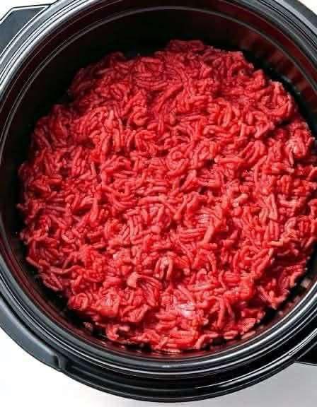 Put raw ground beef in a slow cooker with these 4 ingredients. It’s comfort food perfection.. Full recipe below