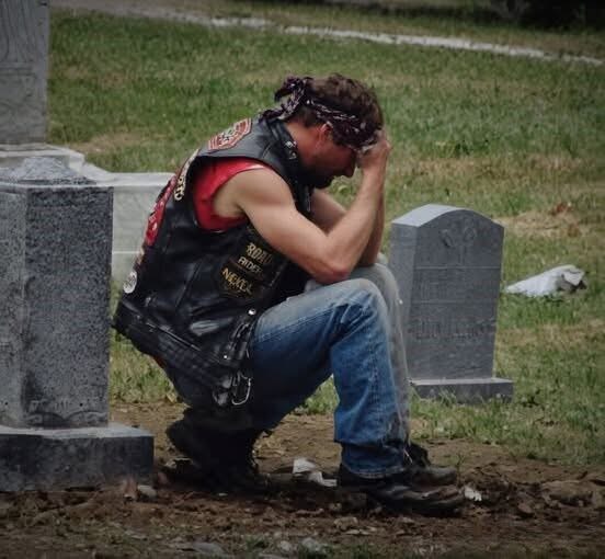 A biker showed up at my wife’s grave every week and I had no idea who he was. For six months I watched him from my car. Same day. Same time. Every Saturday at 2 PM he’d roll up on his Harley, walk to Sarah’s headstone, and sit there for exactly one hour. He never brought flowers. Never said a word that I could see. Just sat cross-legged on the ground next to her grave with his head bowed. The first time I saw him, I thought maybe he had the wrong grave. The cemetery’s big. People get confused. But he came back the next week. And the next. And the next. I started getting angry. Who was this guy? How did he know my wife? Why was he spending an hour every single week at her grave when some of her own family couldn’t be bothered to visit once a month? Sarah died fourteen months ago. She was forty-three. We’d been married twenty years. Two kids. A good life. A normal life. There was nothing in her past that would connect her to a biker. She was a pediatric nurse. She volunteered at church. She drove a minivan. Her idea of rebellion was putting an extra shot of espresso in her latte. But this guy, this biker, he was grieving her like he’d lost someone precious. I could see it in the way his shoulders shook sometimes. In the way he’d press his hand against her headstone before he left. It was driving me crazy. After three months, I couldn’t take it anymore. I got out of my car and walked over while he was there. He heard me coming. Didn’t turn around. Just kept his hand on Sarah’s headstone. “Excuse me,” I said. My voice came out harder than I meant it to. “I’m Sarah’s husband. Mind telling me who you are?” He was quiet for a long moment. Then he stood up slowly and said: “Your wife was my…… (continue reading in the C0MMENT)